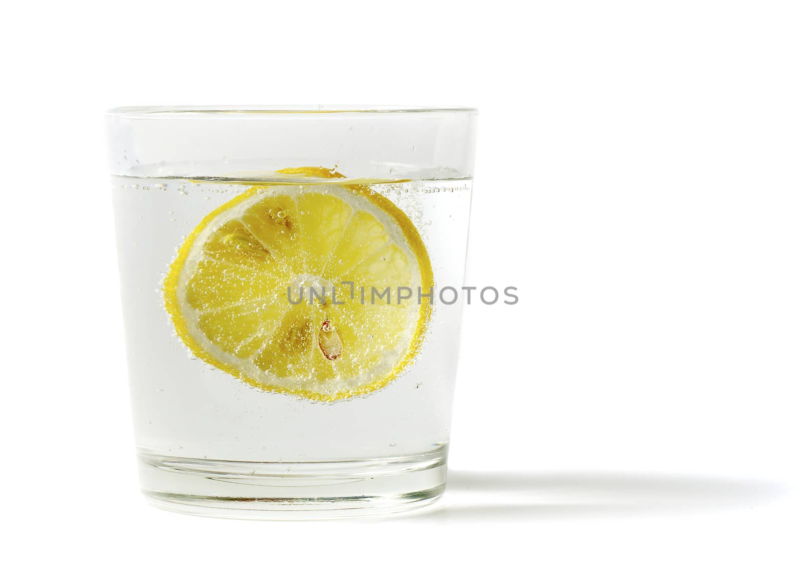 lemon in glass on a white background