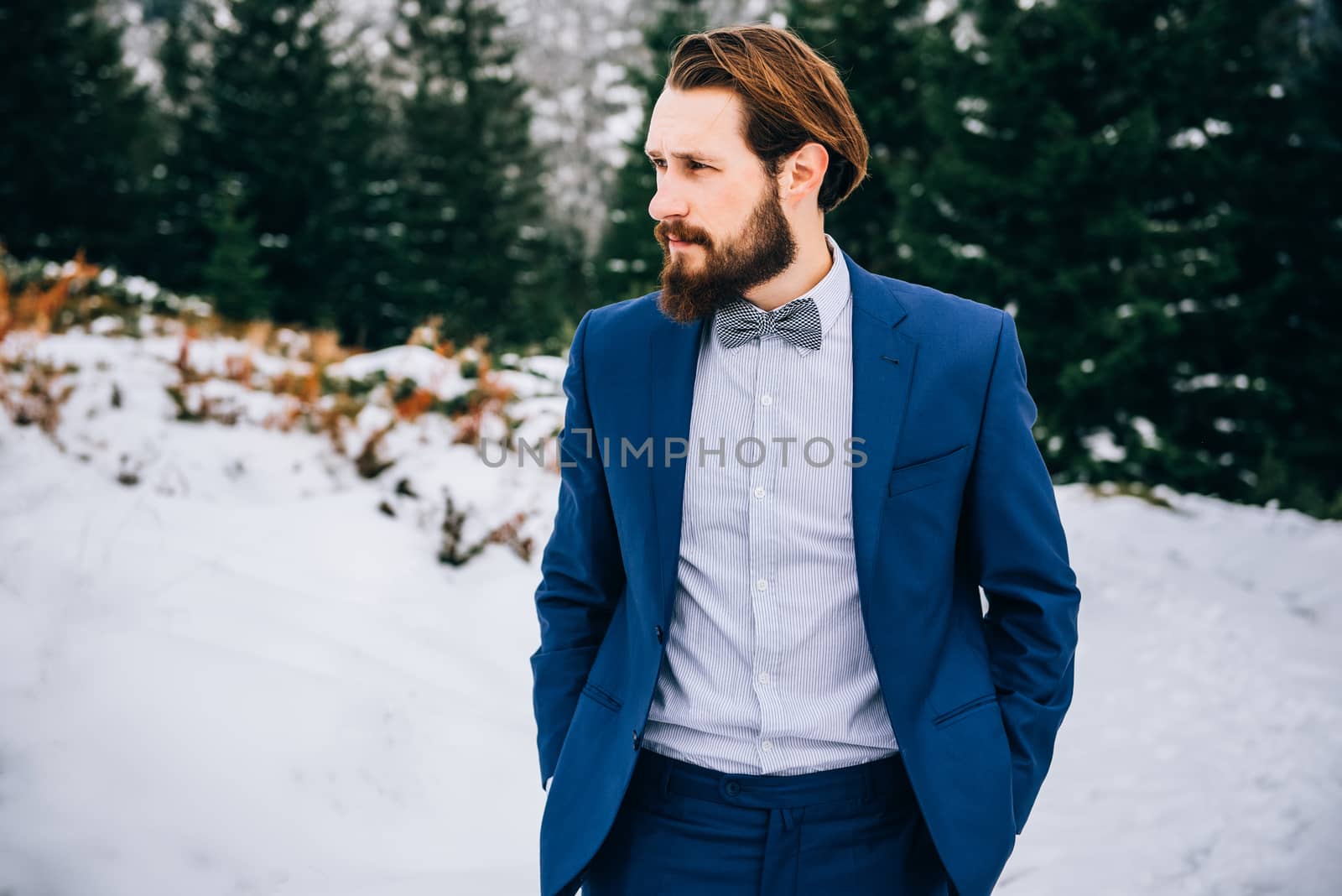 groom in a blue suit in the mountains Carpathians by Andreua