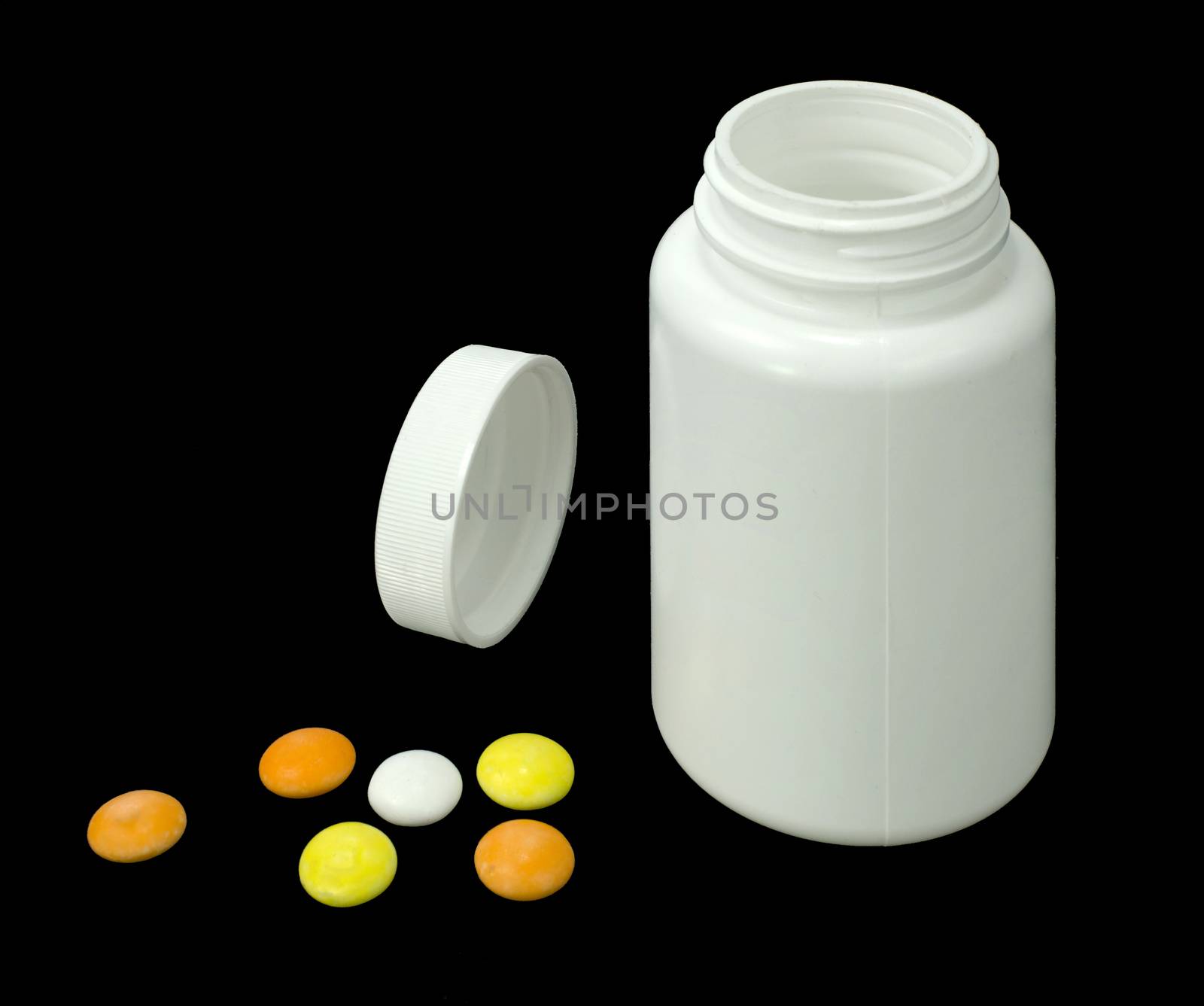 six pills of a different colors with white jar on a black background