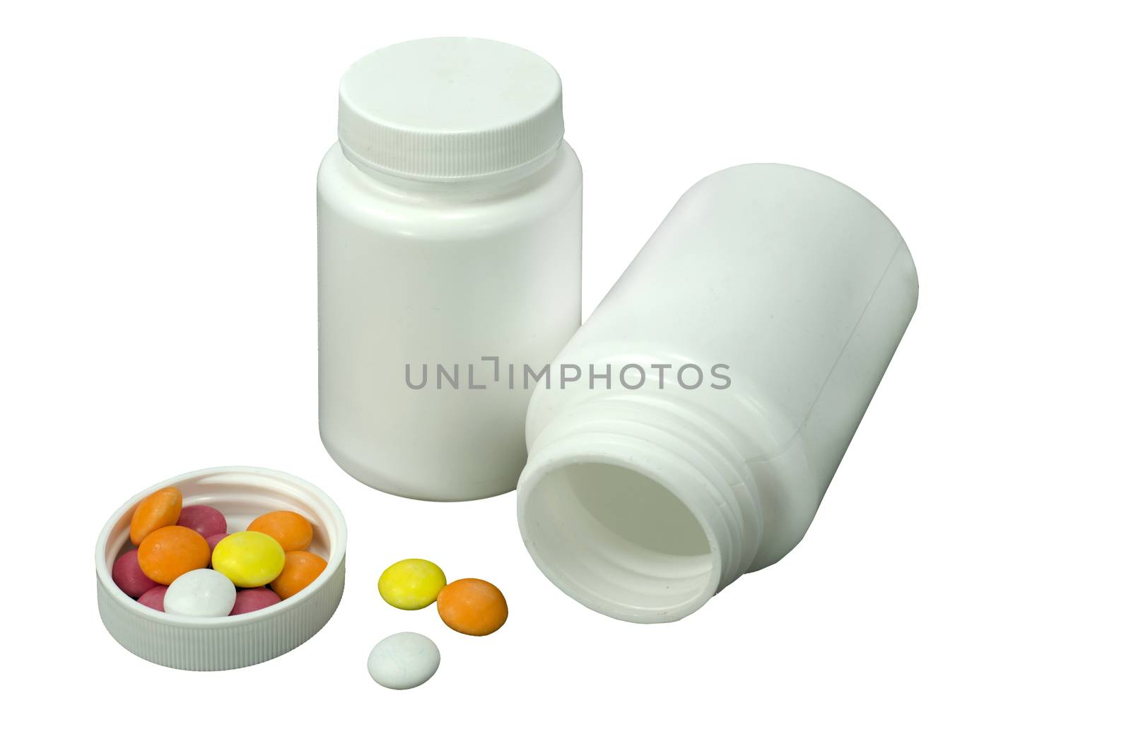 some pills of a different colors with two white jar on a white background