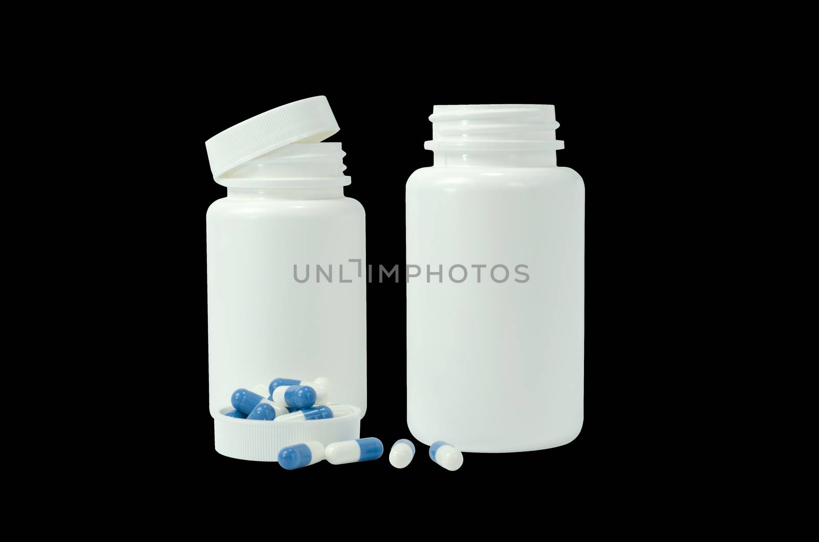 some pills of a white and blue colors with two white jar on a black background