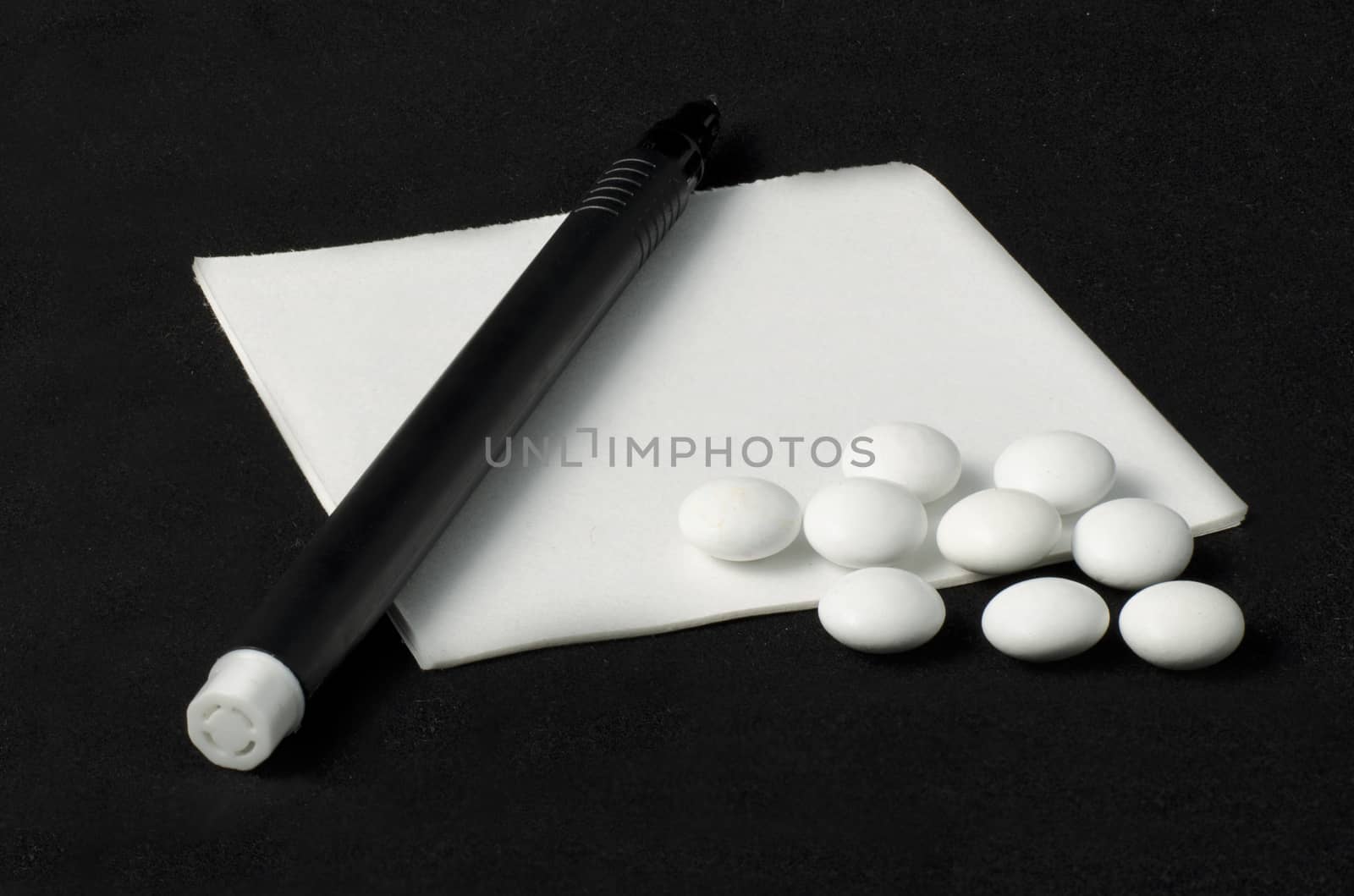 prescription, pills and pen on a dark background