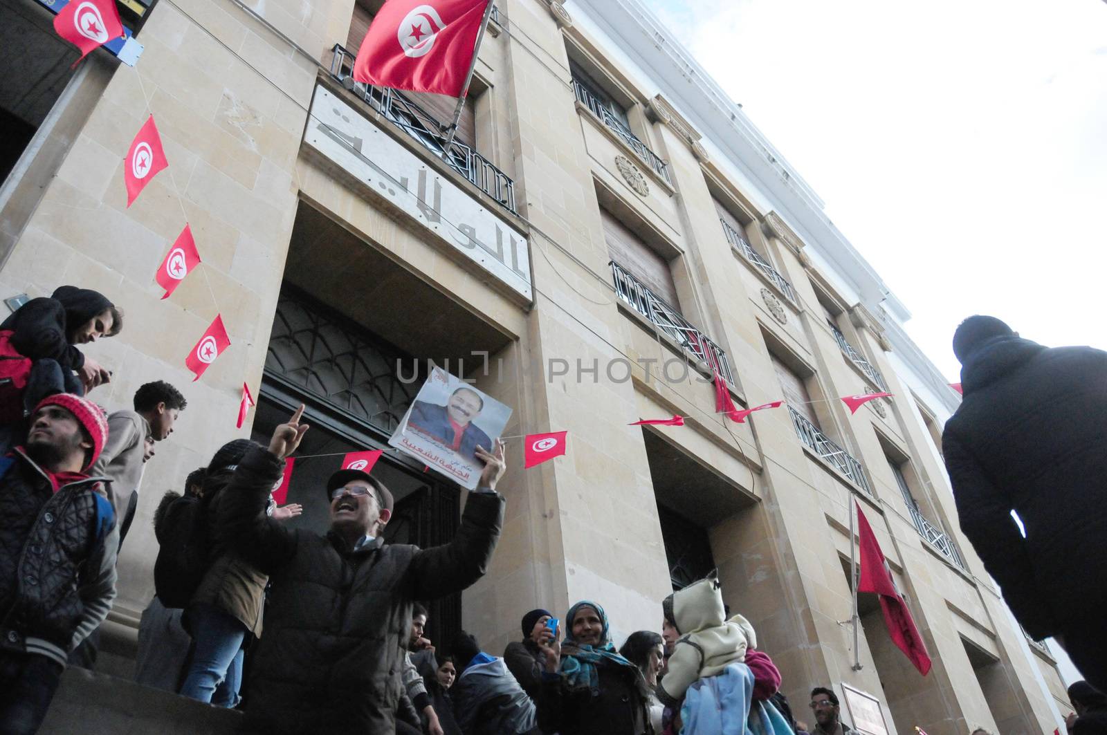 TUNISIA, Tunis: Tunisians shout slogans outside the headquarters of Tunis Governorate, on Habib Bourguiba, during an anti-government demonstration on January 20, 2016  in solidarity with demonstrators demanding jobs in the central Tunisian city of Kasserine Authorities imposed a curfew on the impoverished city of Kasserine, where tensions have been high since January 16, 2016 when a young unemployed man suffered a fatal electric shock during a protest
