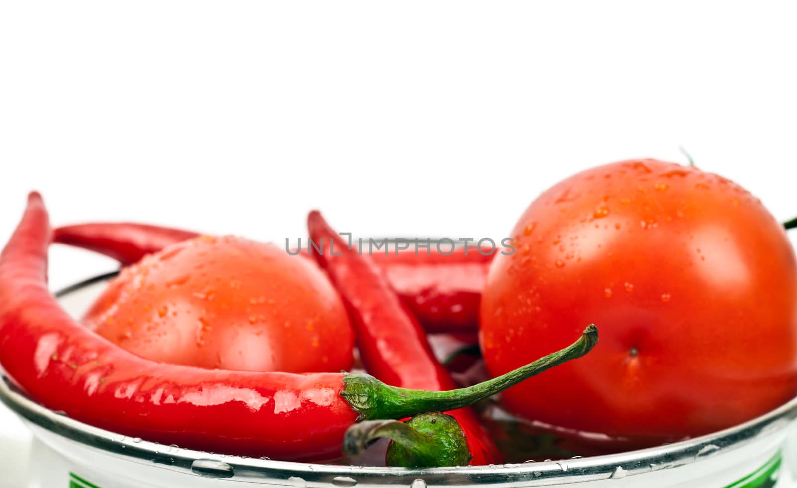 tomatoes and hot peppers on a white background