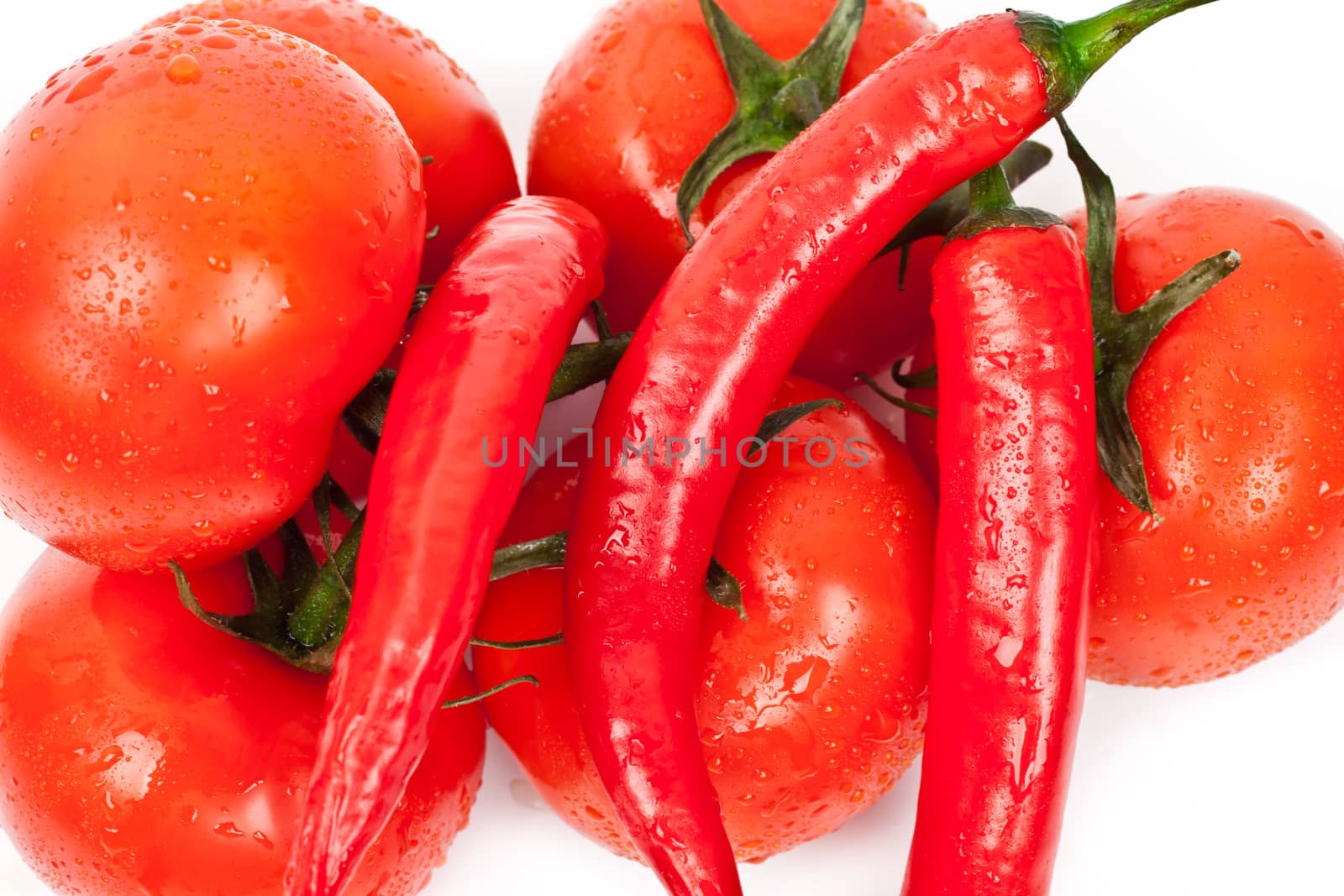 tomatoes and hot peppers on a white background