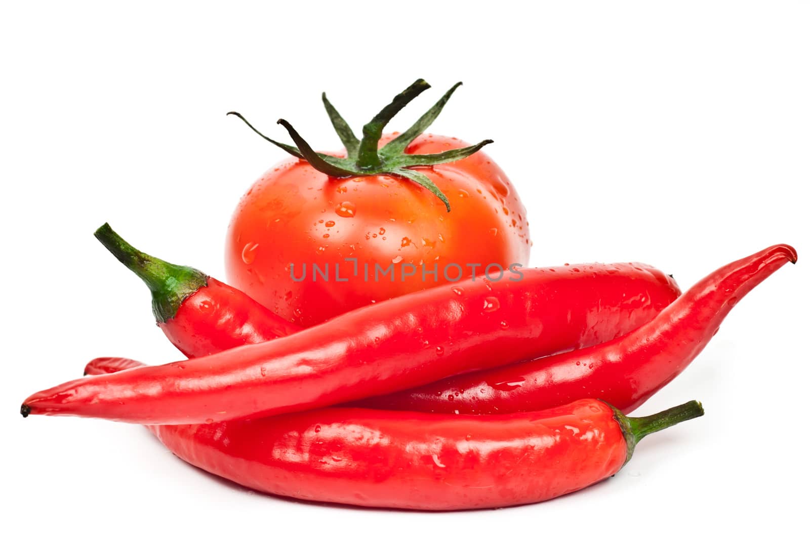 tomatoes and hot peppers on a white background