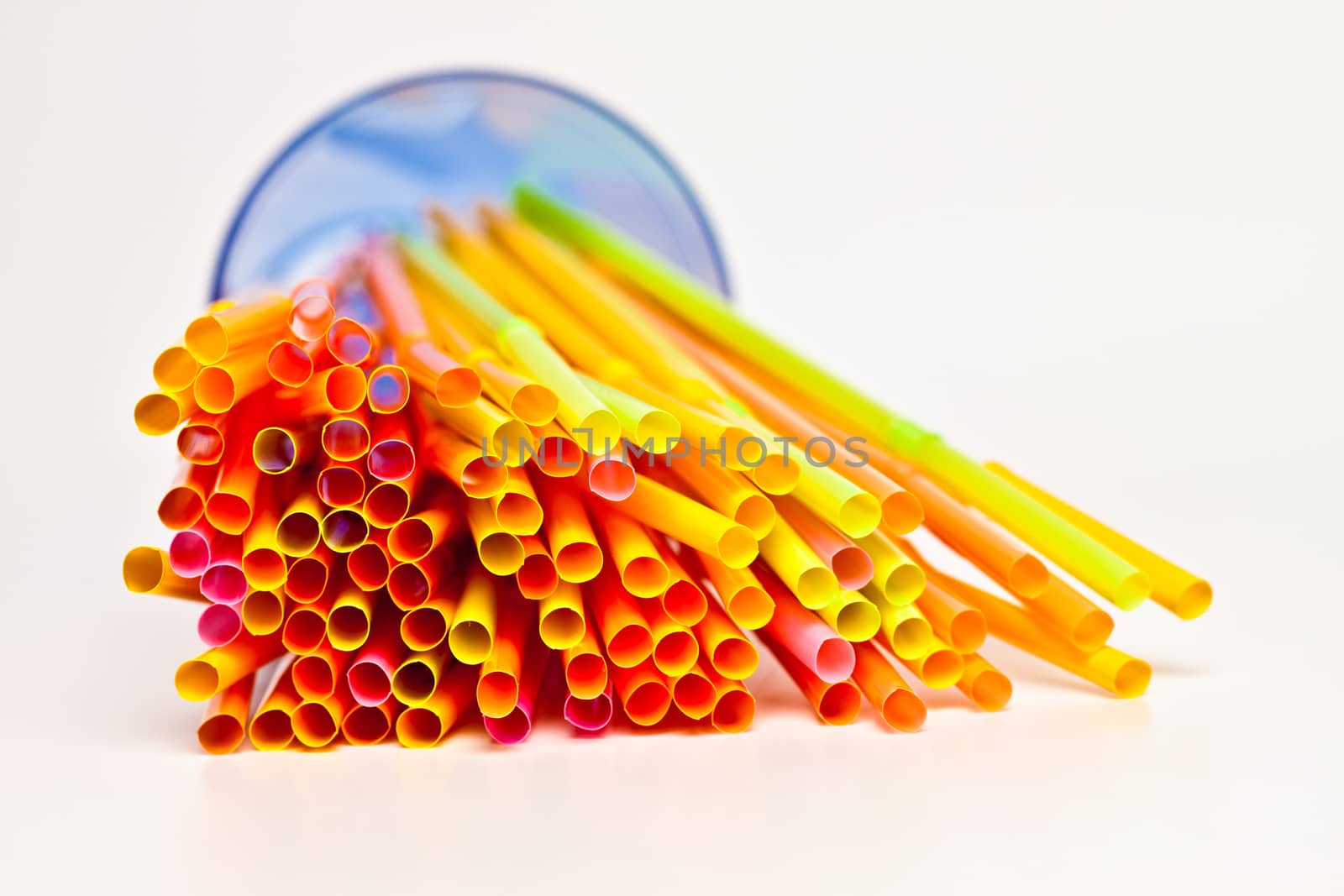 tube for a cocktail in a glass on a white background