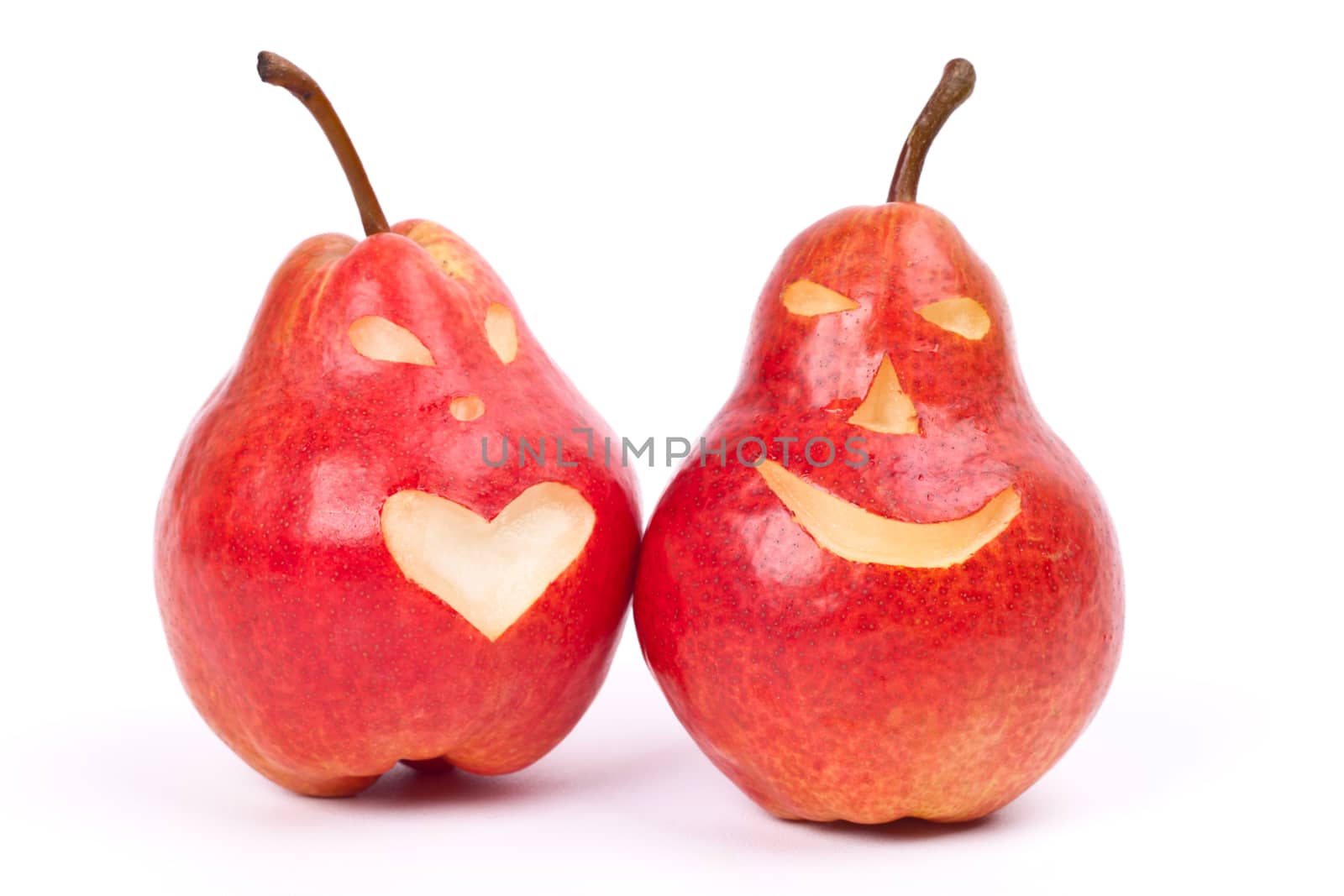 two red pears with eyes and mouth on a light background
