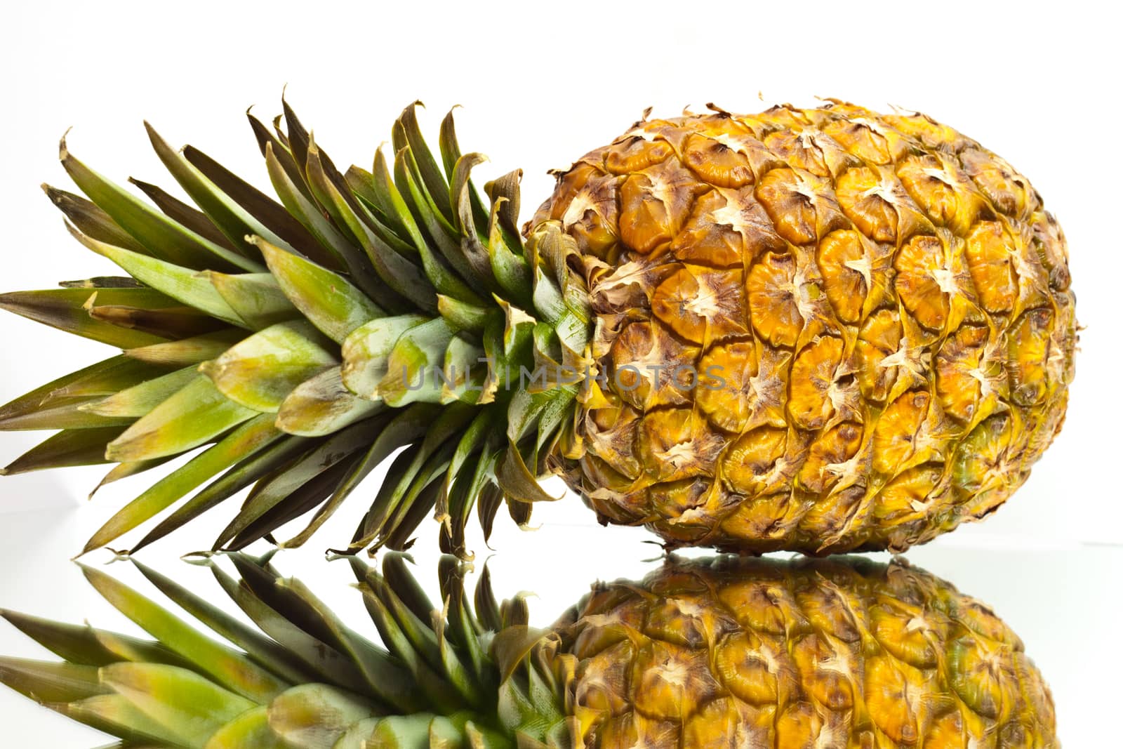 ripe pineapple in the reflection on the background