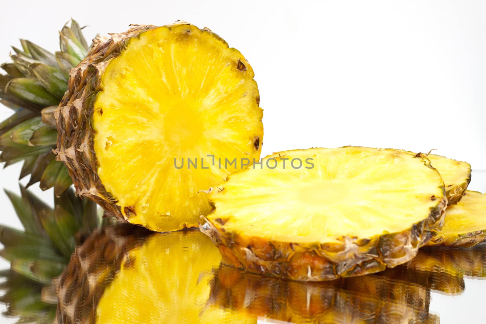 ripe pineapple sliced ​​on a light background