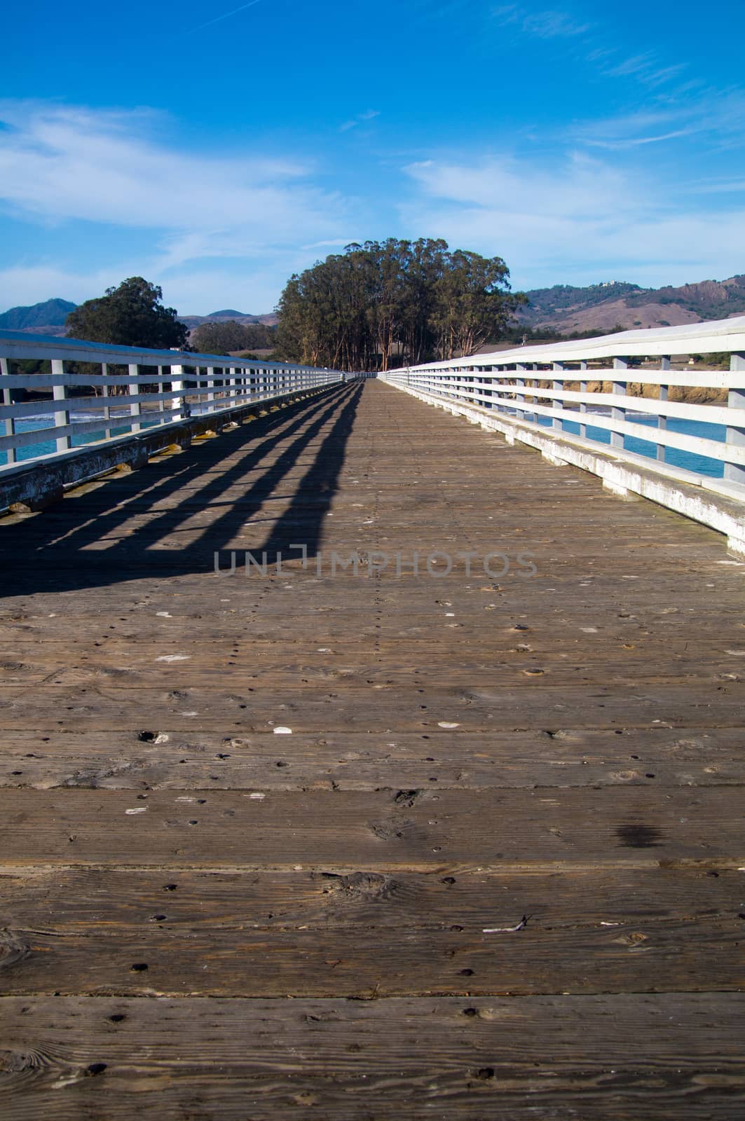 Long pier leads back to rolling hills of California by emattil