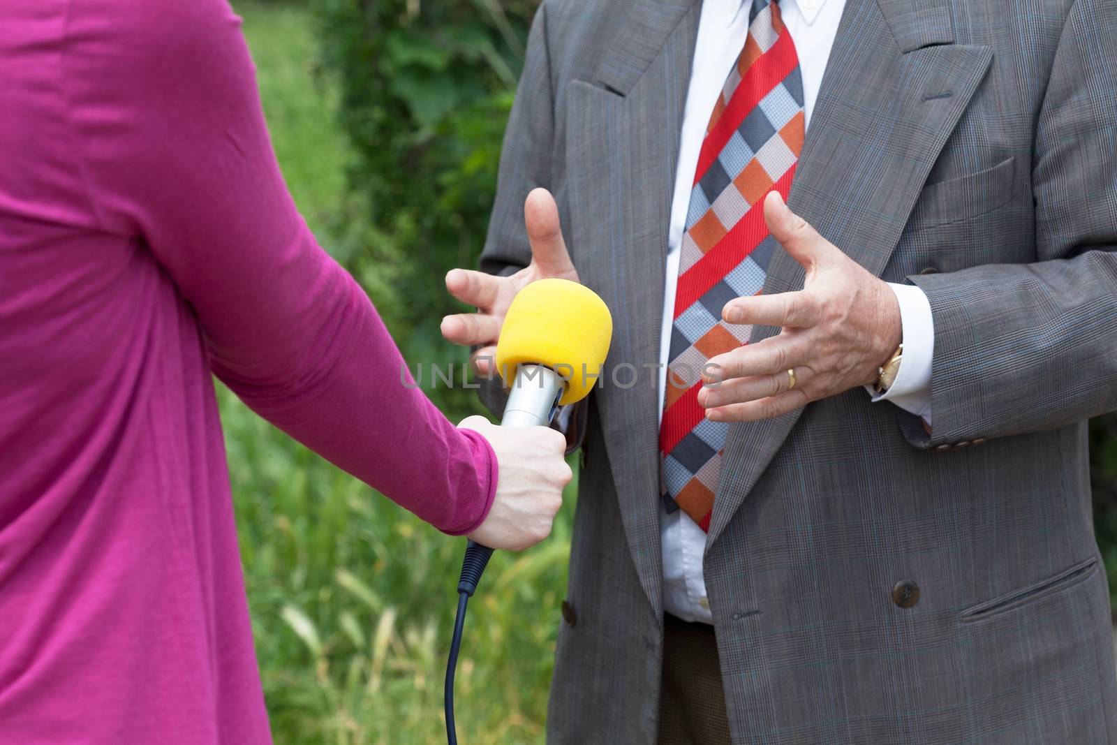 Reporter making media interview with businessperson or politician 