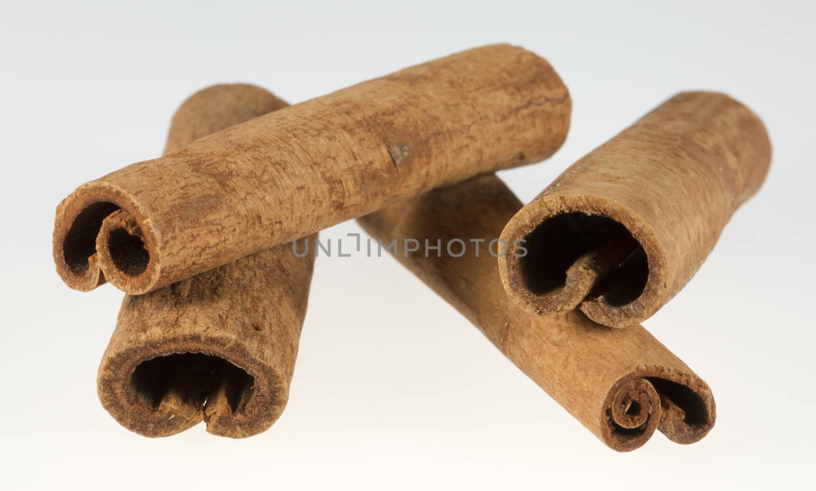 Stacked Cinnamon Sticks close up on a white background.