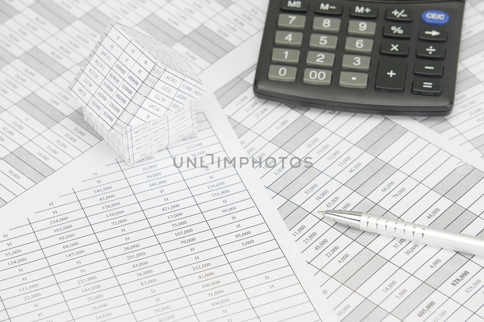 Silver pen with house and calculator on finance account  by eaglesky