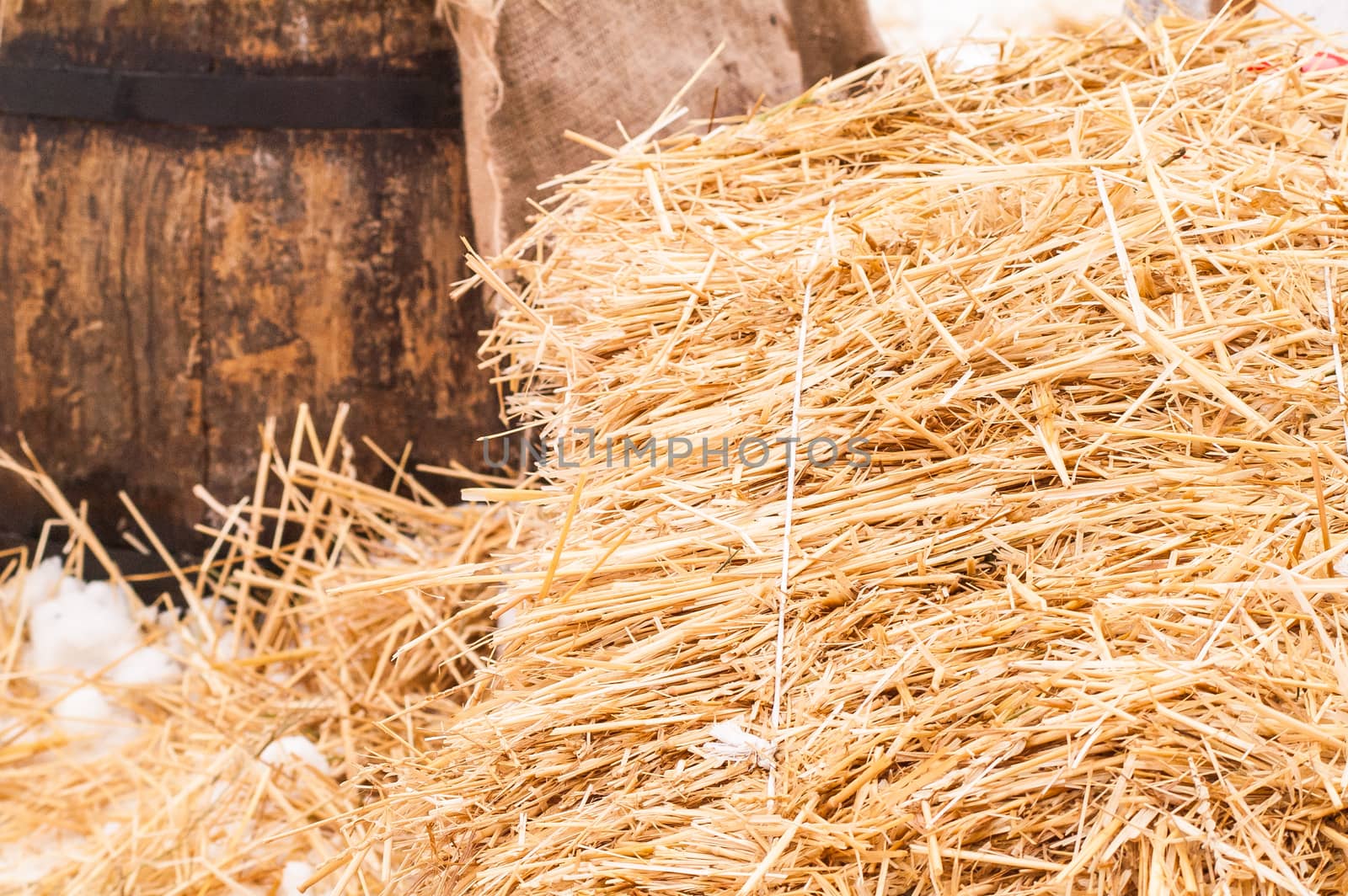 wooden barrel near the straw on the snow