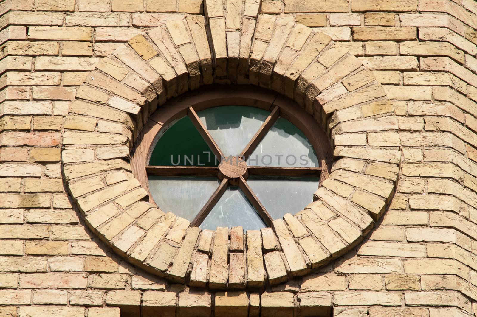 round window in a brick building on a sunny day