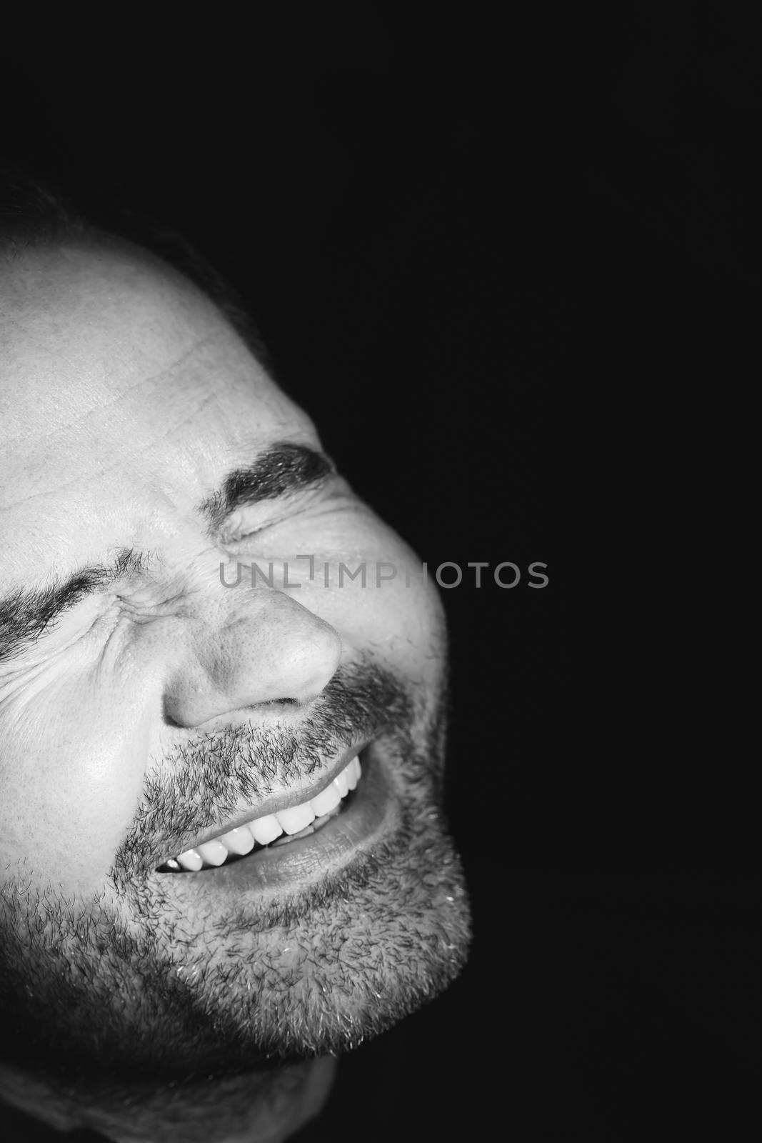 Close-up of business man smiling to the brightness by CatherineL-Prod