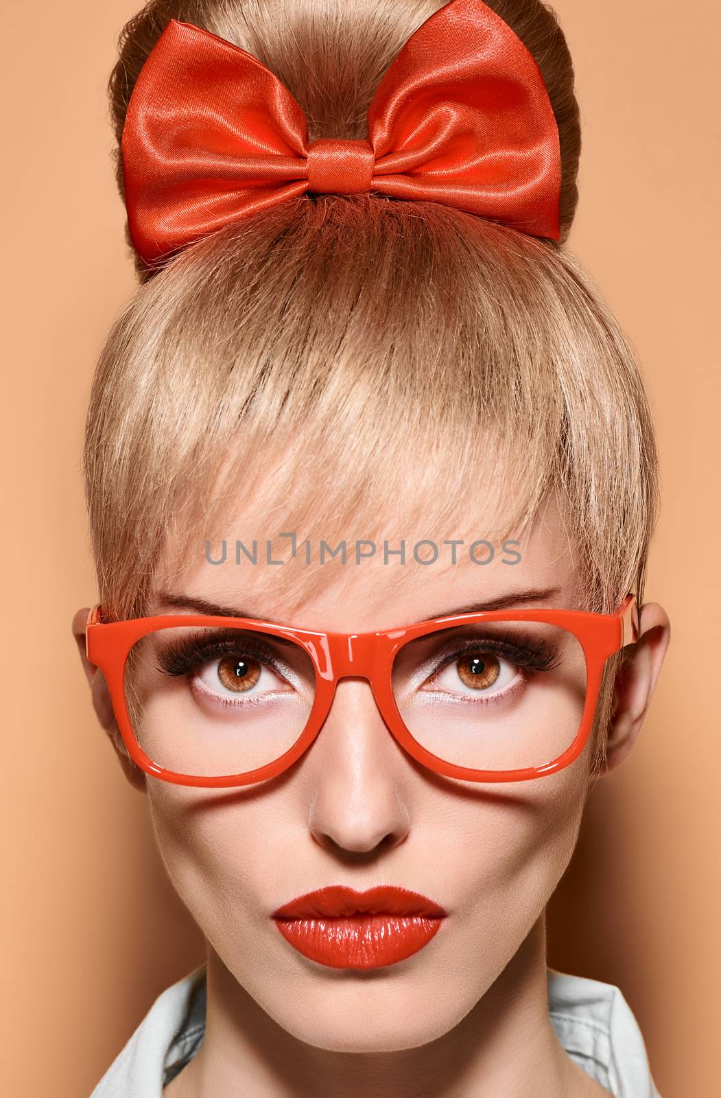 Beauty fashion portrait woman in stylish glasses. Attractive pretty blonde sexy hipster girl. Confidence, success, Pinup hairstyle, trendy red bow makeup,lips.Unusual playful, creative.Vintage,vanilla