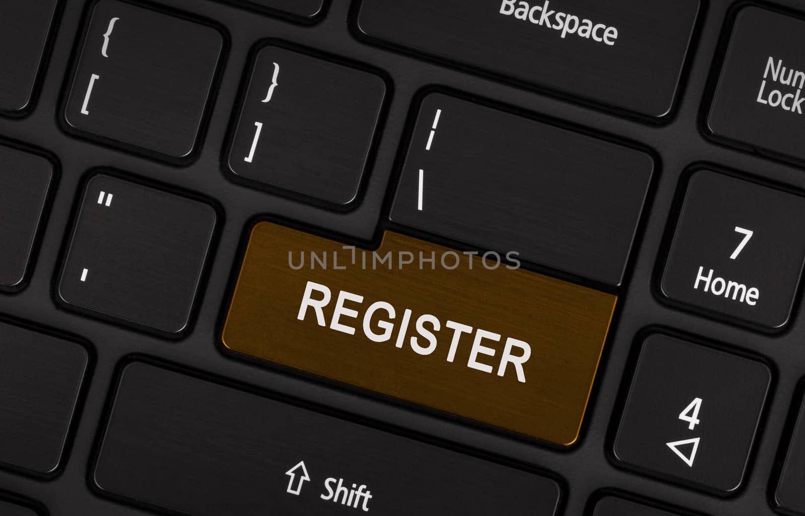 Brown register button on laptop keyboard close-up