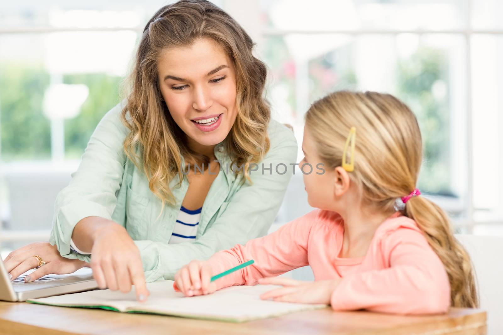 Mother checking daughters homework by Wavebreakmedia
