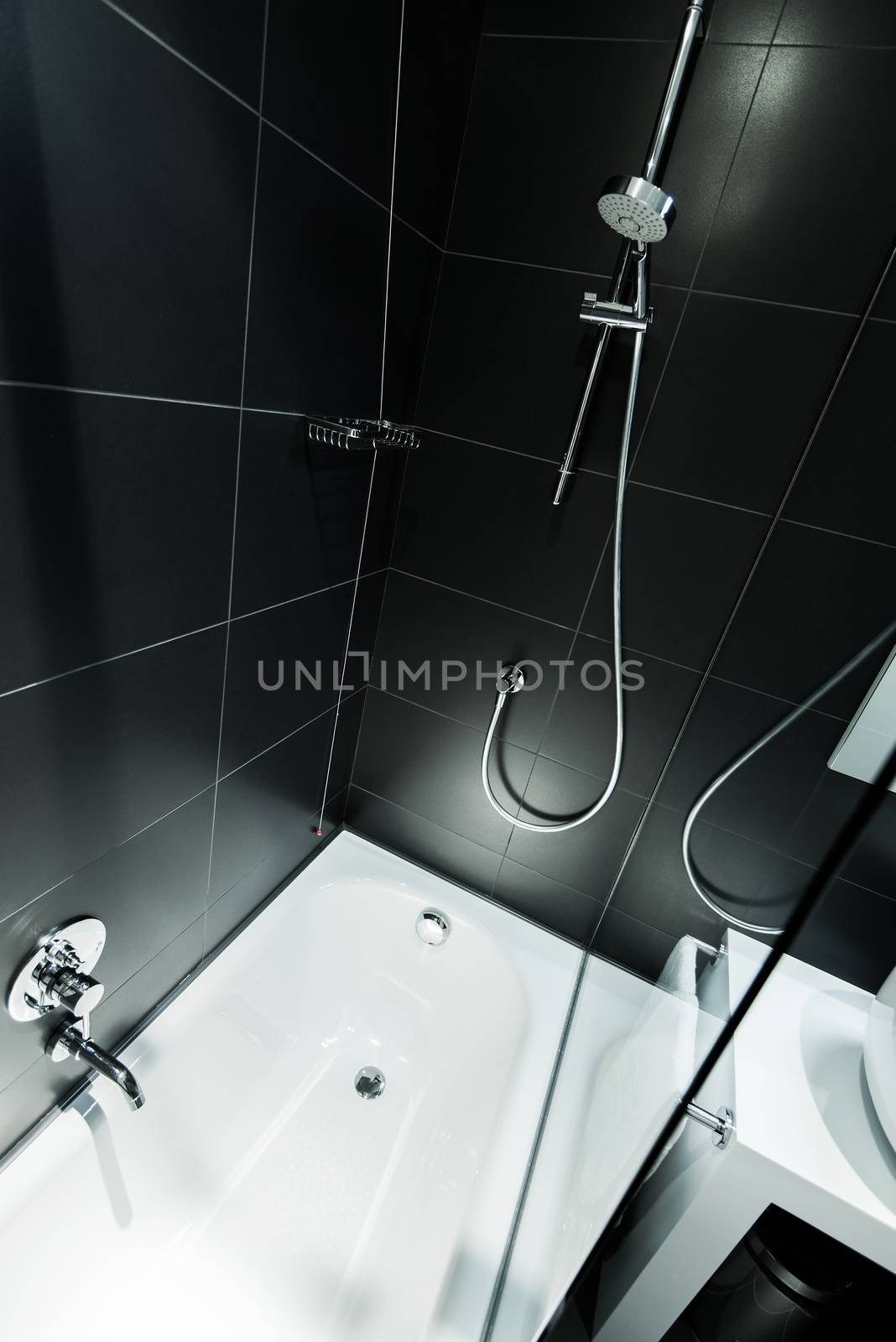 Black Modern Bathroom Design. Bath Tube and Shower. Black Tiles.