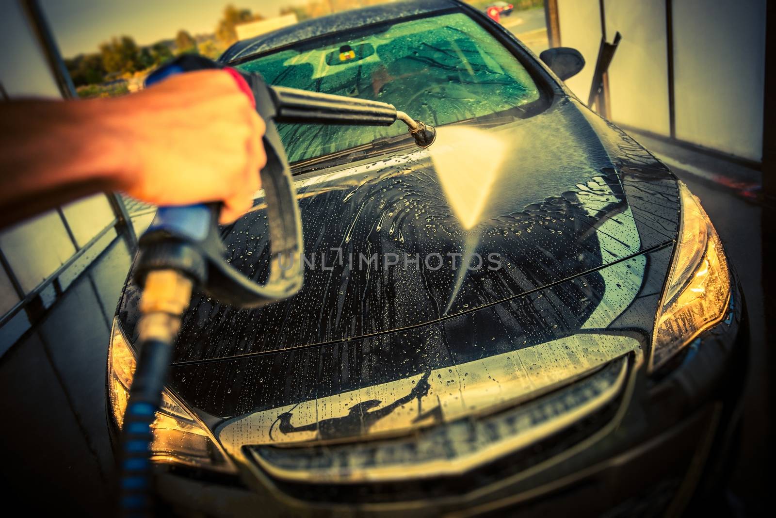 Car Cleaning in a Car Wash. High Pressure Car Washing. Taking Care of a Car.