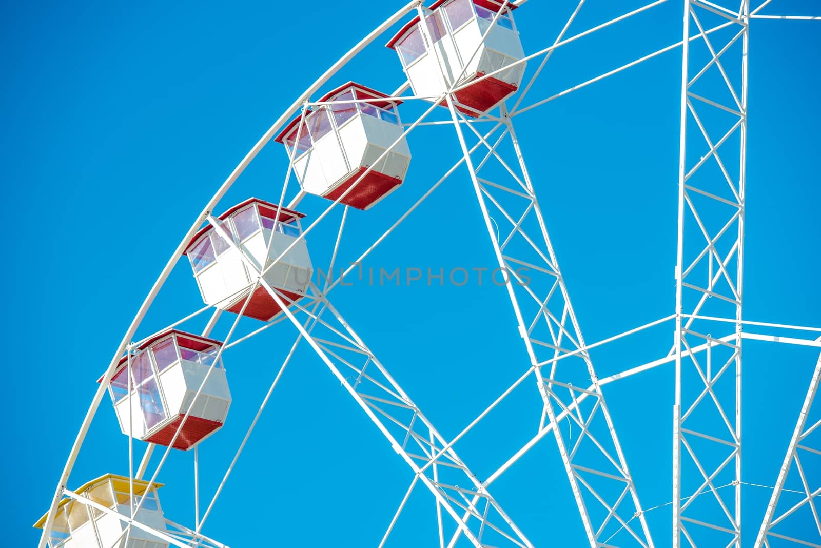 Ferris Wheel Closeup Over Clear Blue Sky. Ferris Wheel Fun.