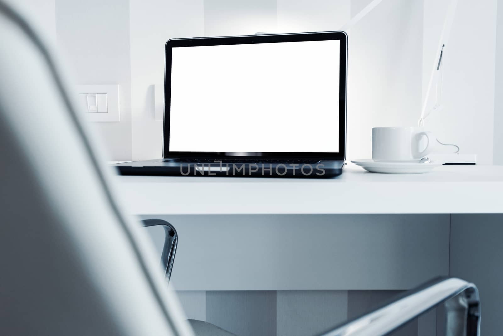 Modern Office Workstation with Laptop Computer. White Furnished Office Space.