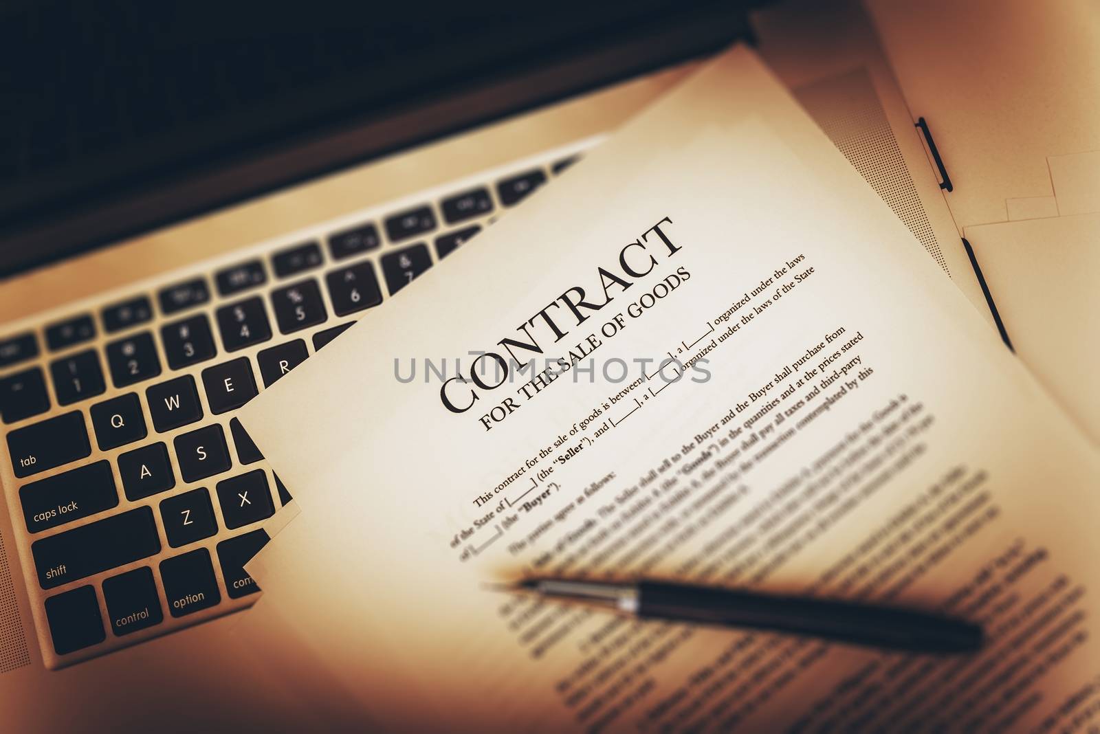 Contract For The Sale of Goods Concept Photo. Contract on the Laptop Computer.