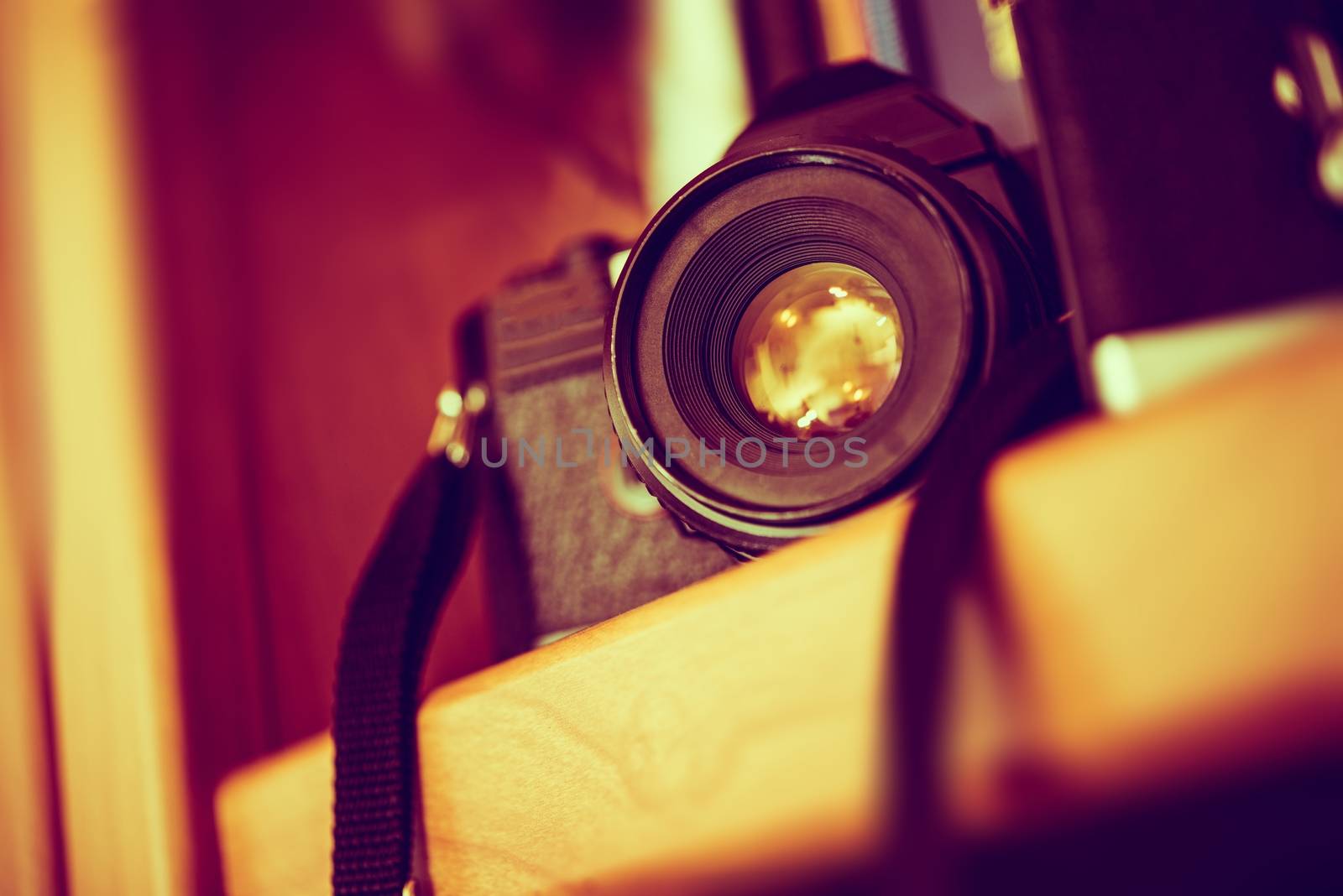 Vintage Film Camera on a Bookshelf. Aged Camera Closeup. Photography Technologies.