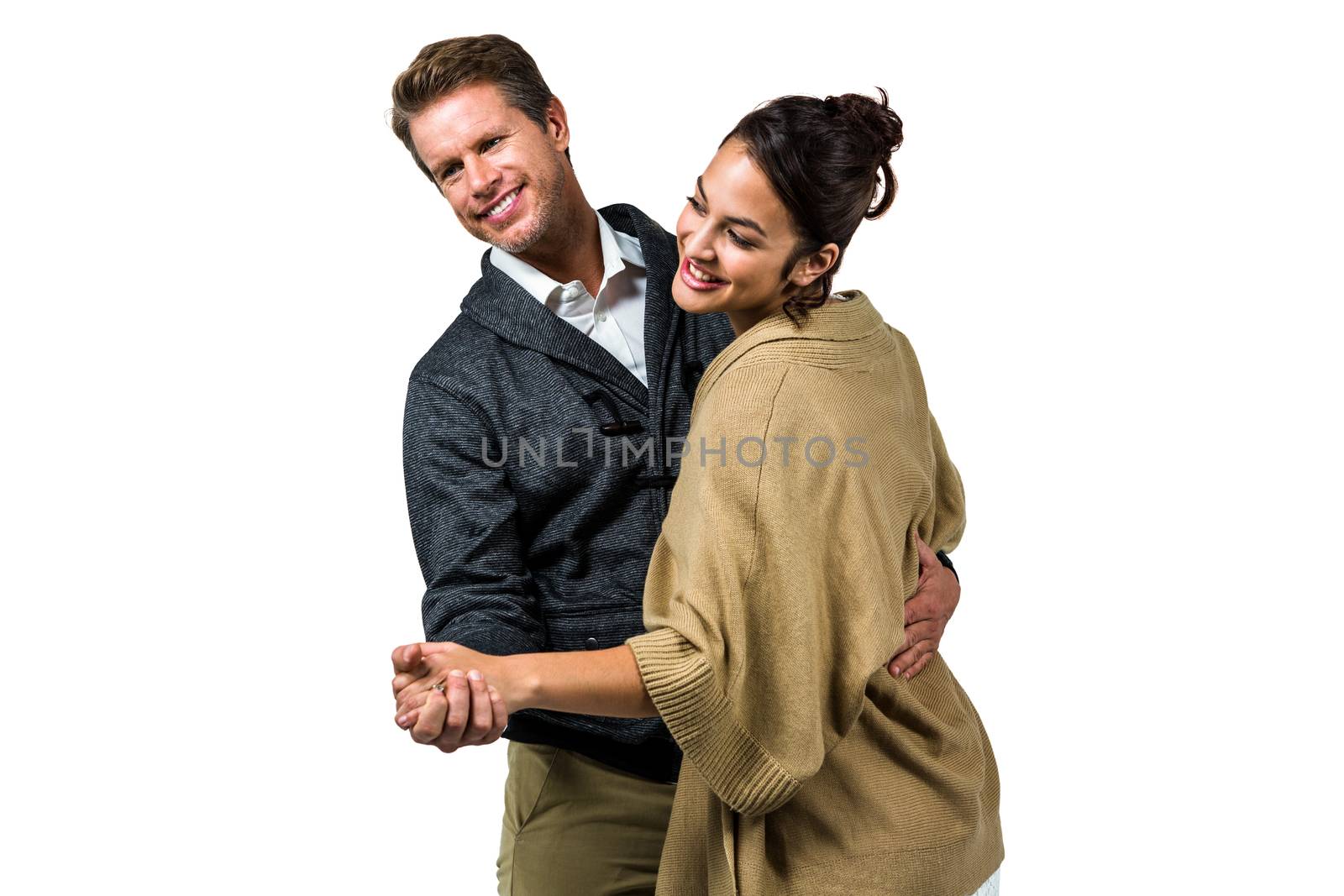 Happy romantic couple dancing against white background