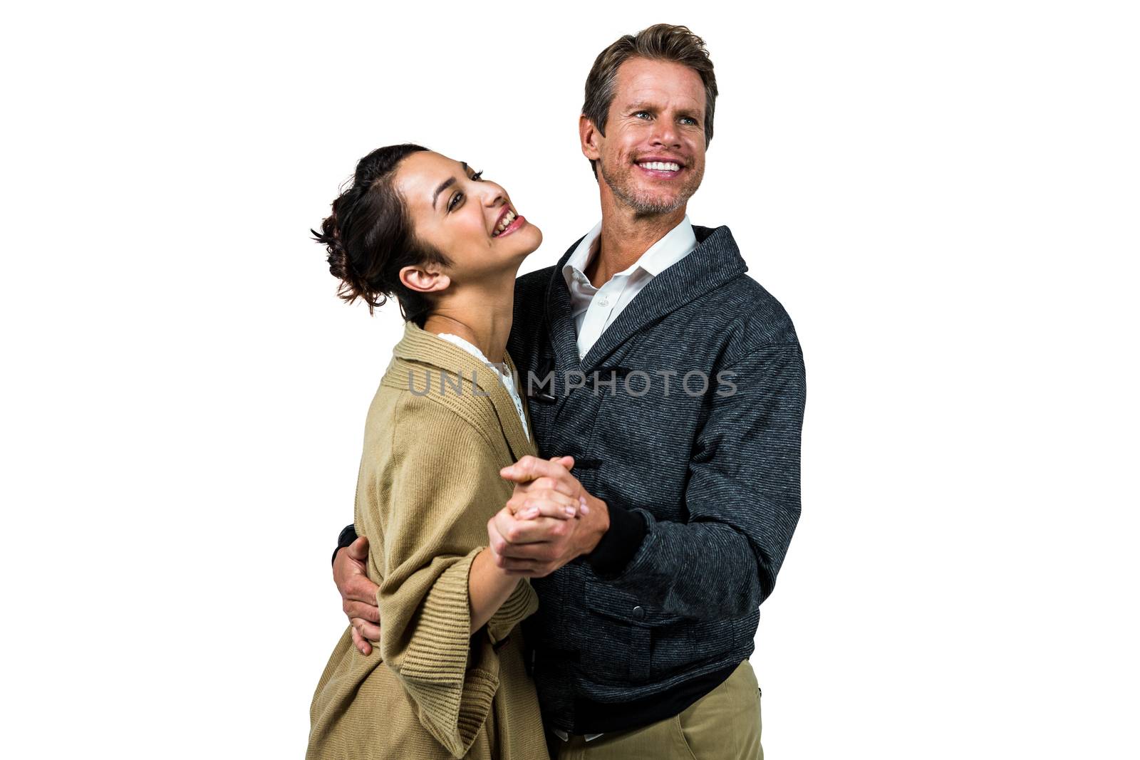 Cheerful romantic couple dancing against white background
