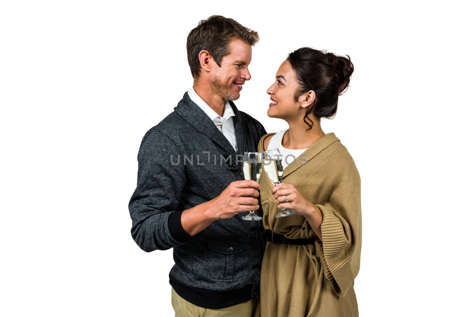 Happy romantic couple with champagne flute against white background