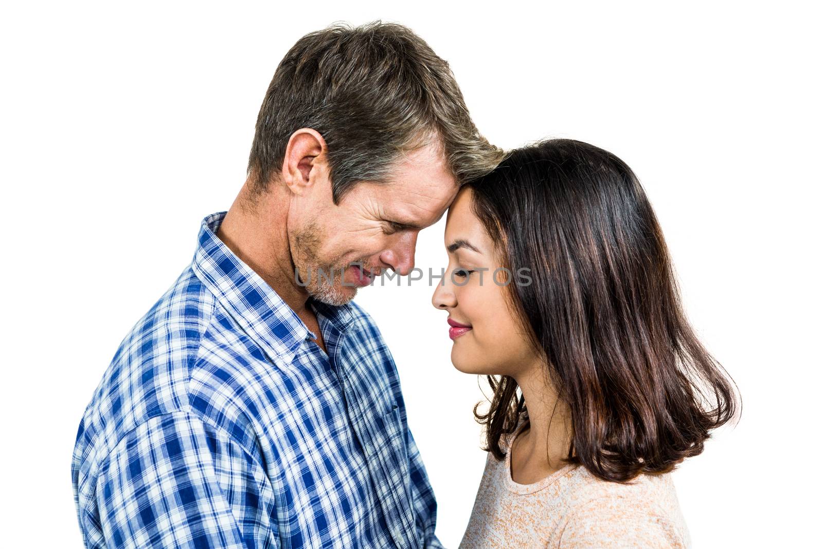 Close-up of romantic couple standing face to face against white background