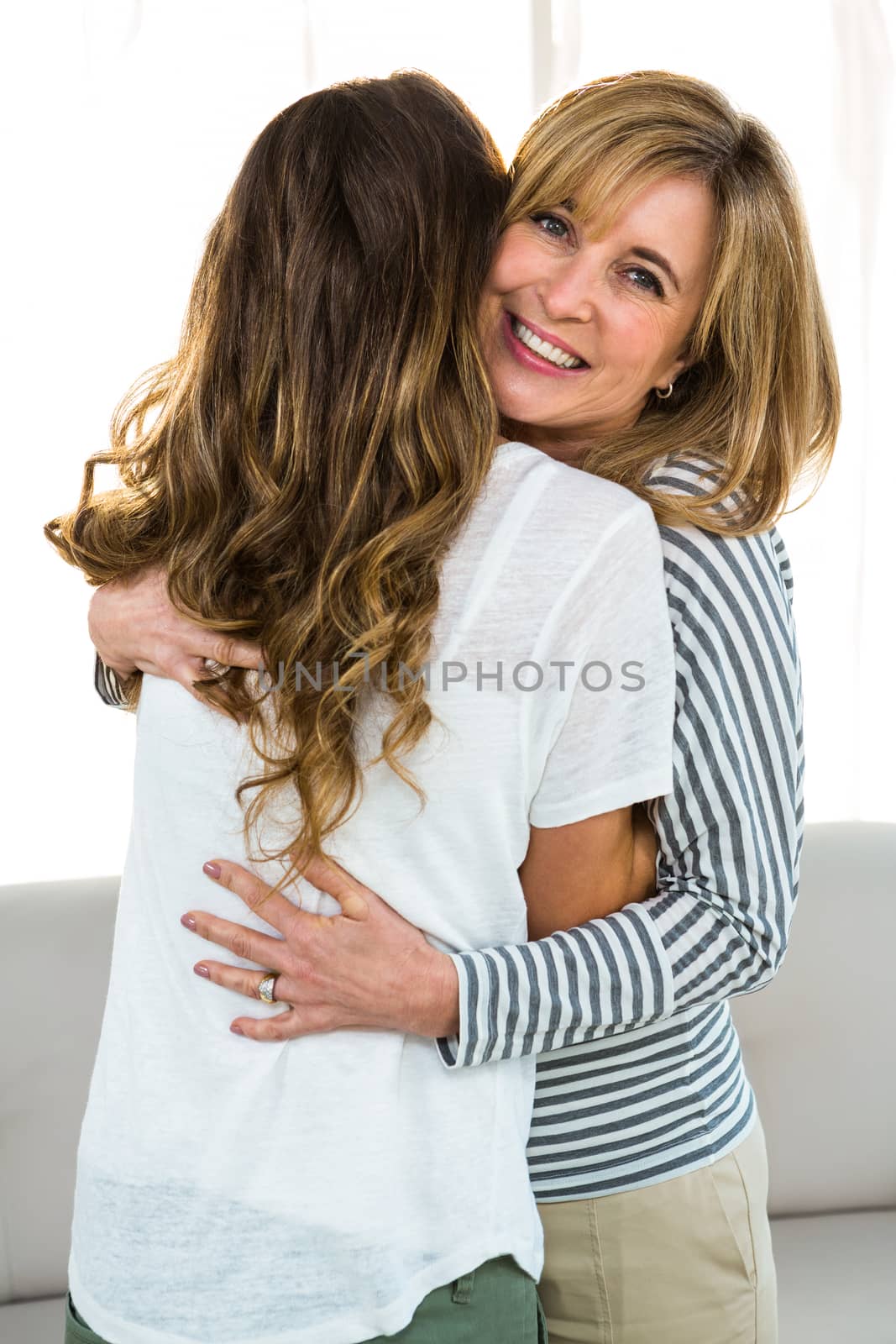 Mother and daughter hugging by Wavebreakmedia