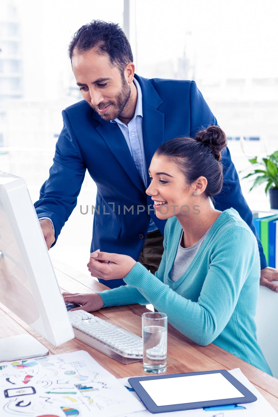 Young businessman and businesswoman working on computer by Wavebreakmedia