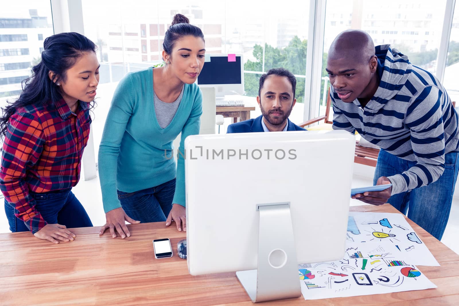 Business team in front of computer at desk by Wavebreakmedia