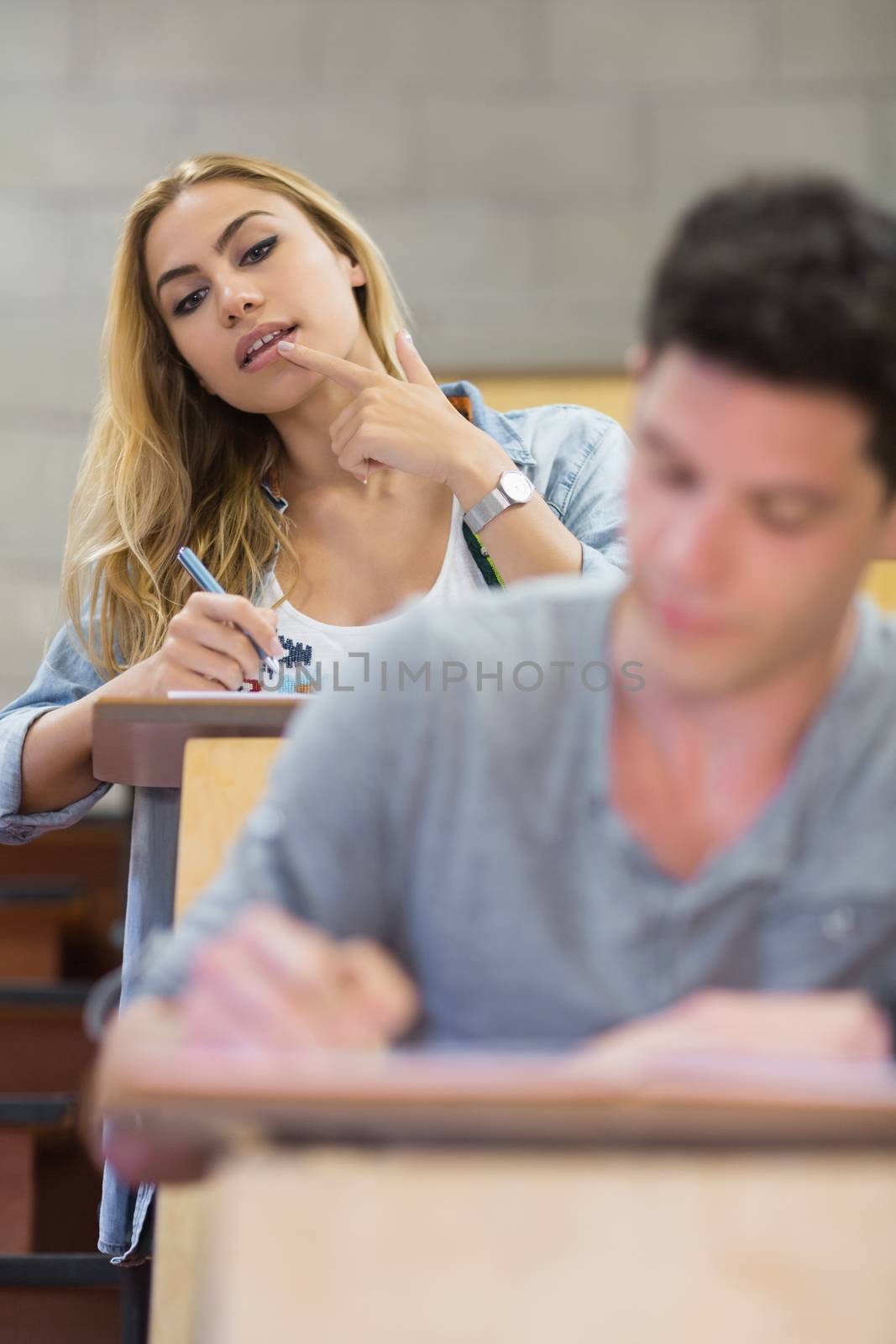 Female student cheating on her classmate  by Wavebreakmedia