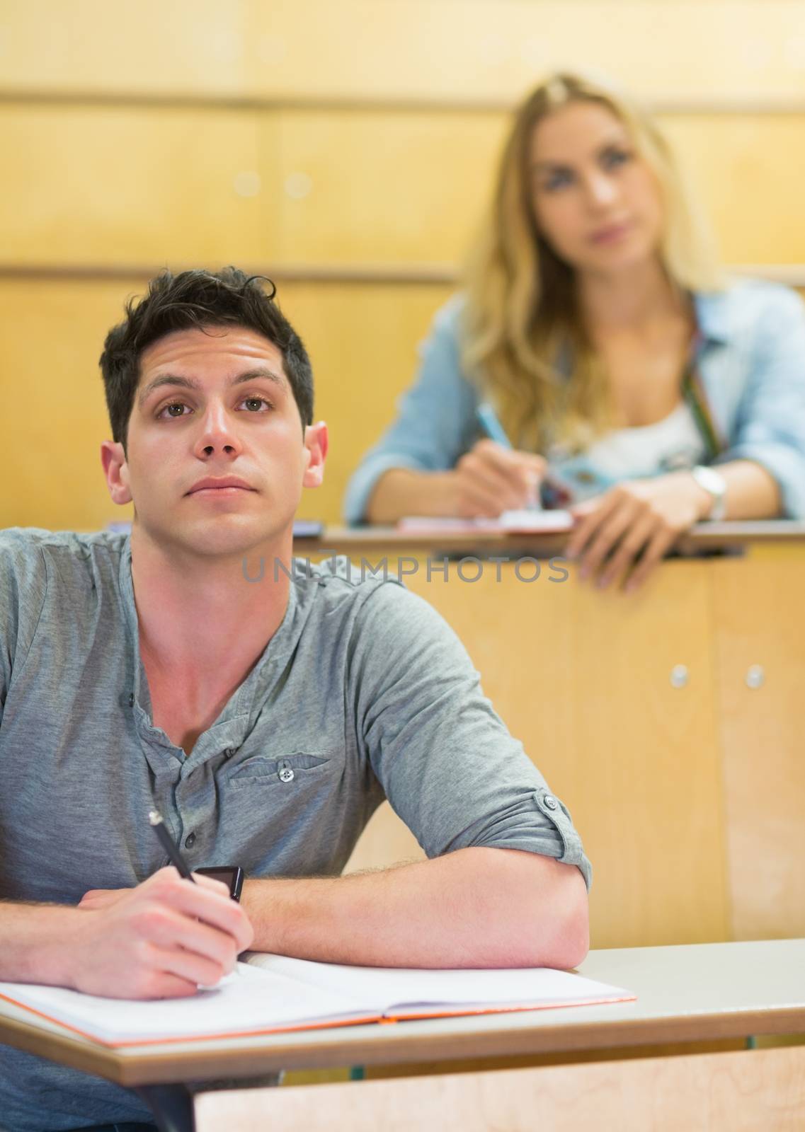 Thoughtful male student during class at the lecture hall