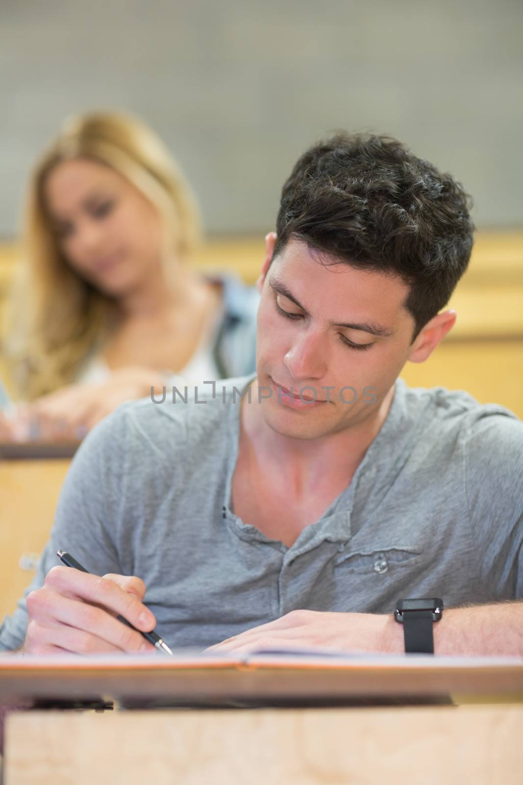 Serious male student during class in the lecture hall