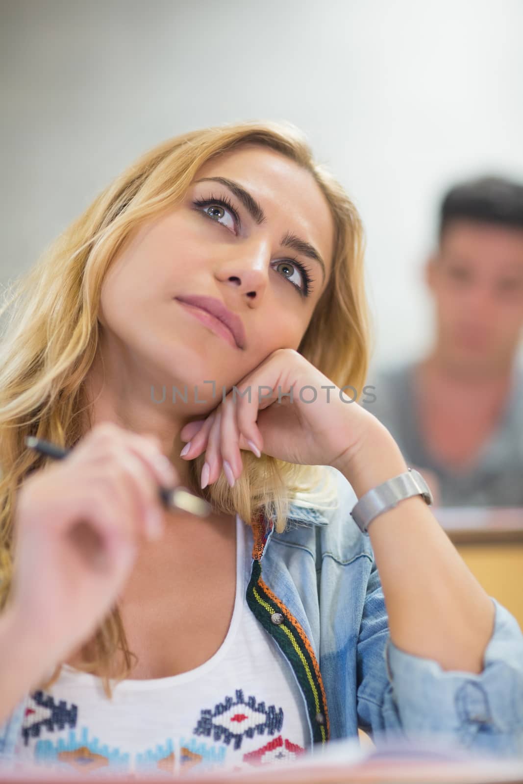 Thoughtful female student during class at the lecture hall