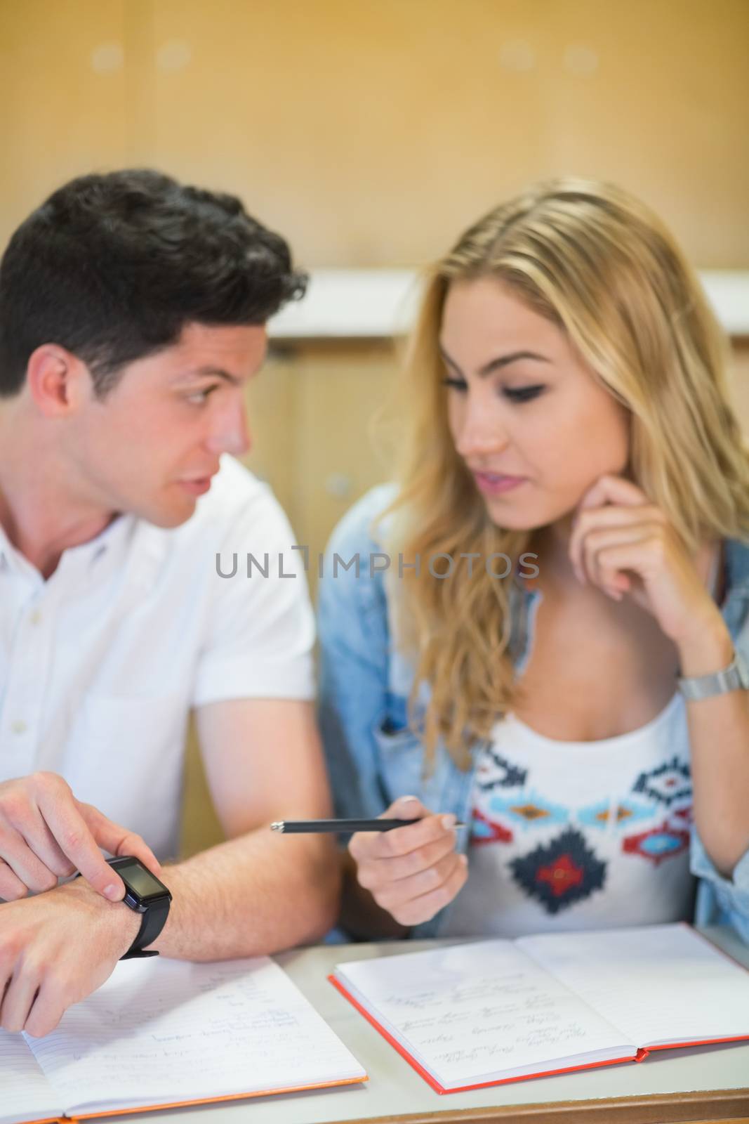 Two students timing their work at the university 