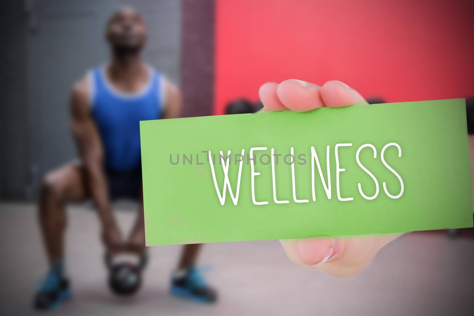 The word wellness and hand showing card against 