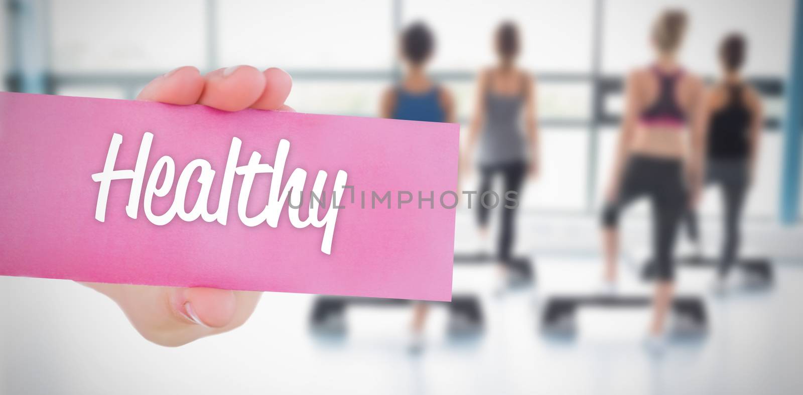 The word healthy and young woman holding blank card against 