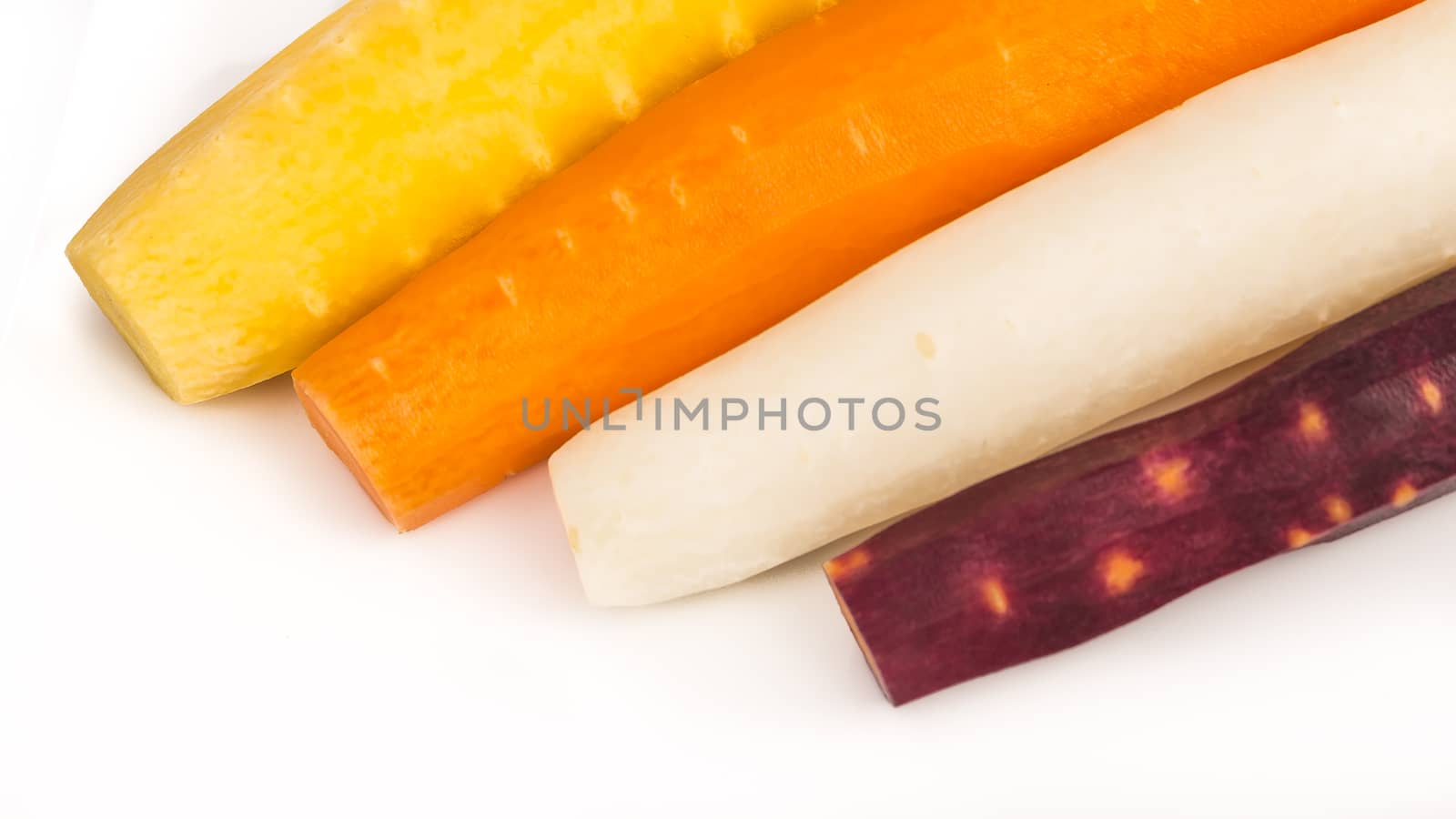 raw yellow, white, orange, red carrots by CatherineL-Prod