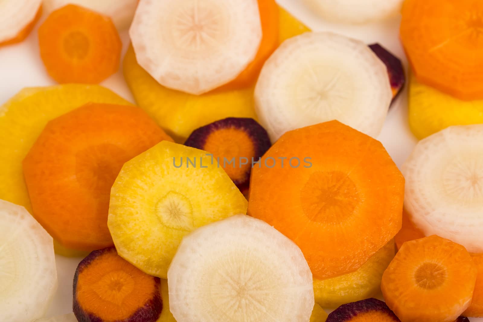 raw yellow, white, orange, red carrots by CatherineL-Prod