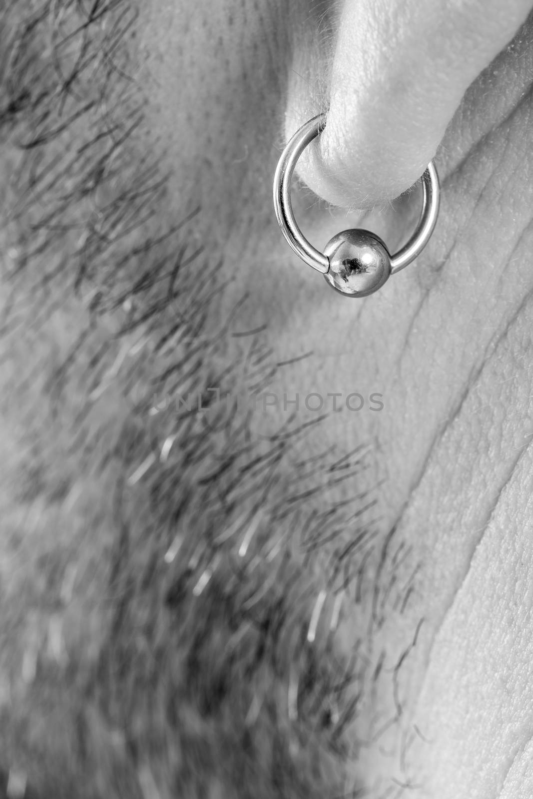 pierced ear of a  man by CatherineL-Prod
