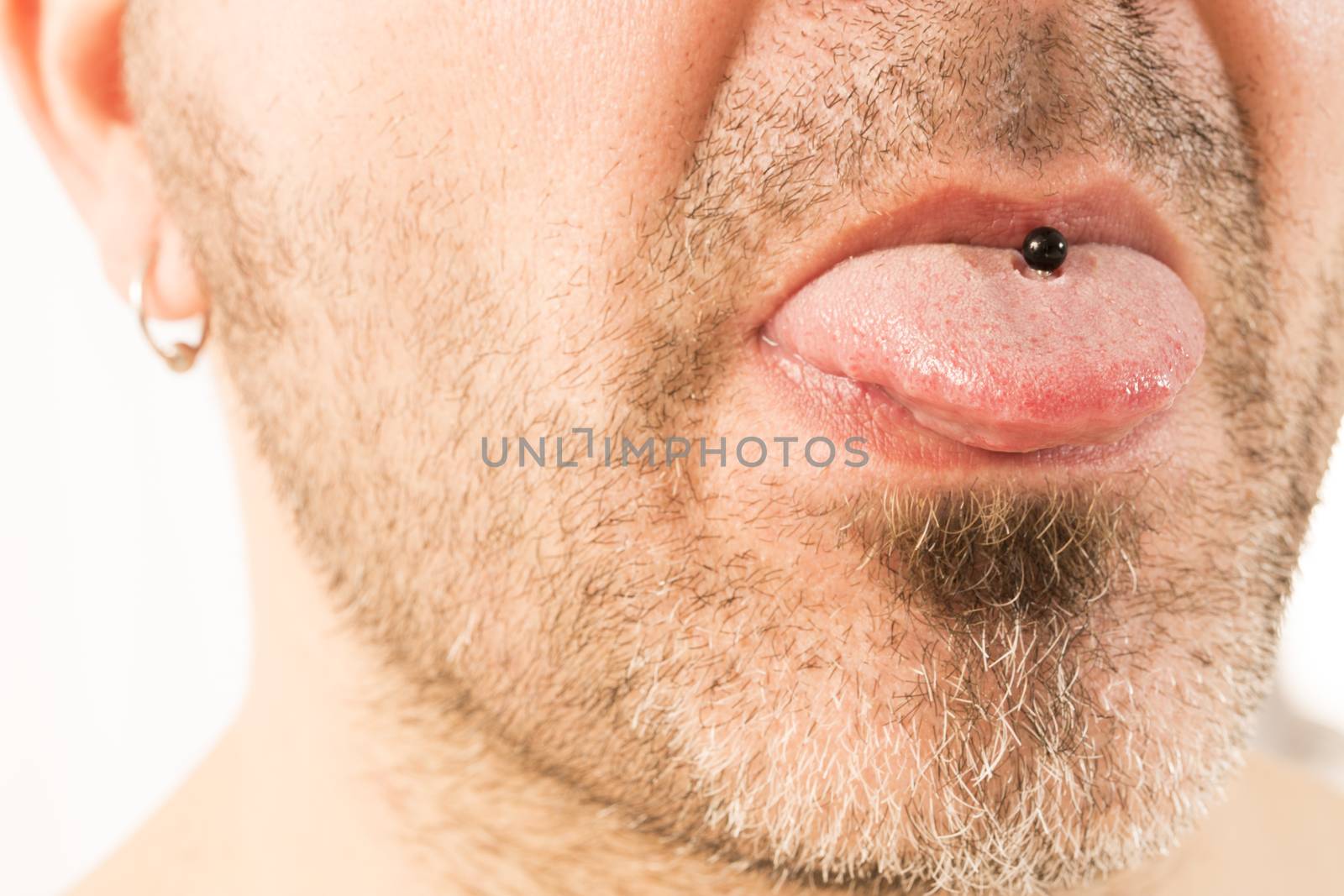 close-up of a mature man showing off his tongue ring