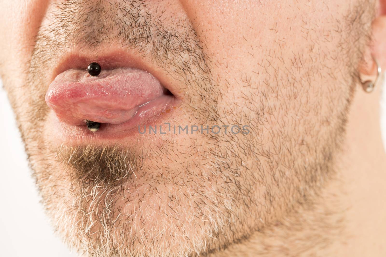 Man showing off his tongue ring by CatherineL-Prod