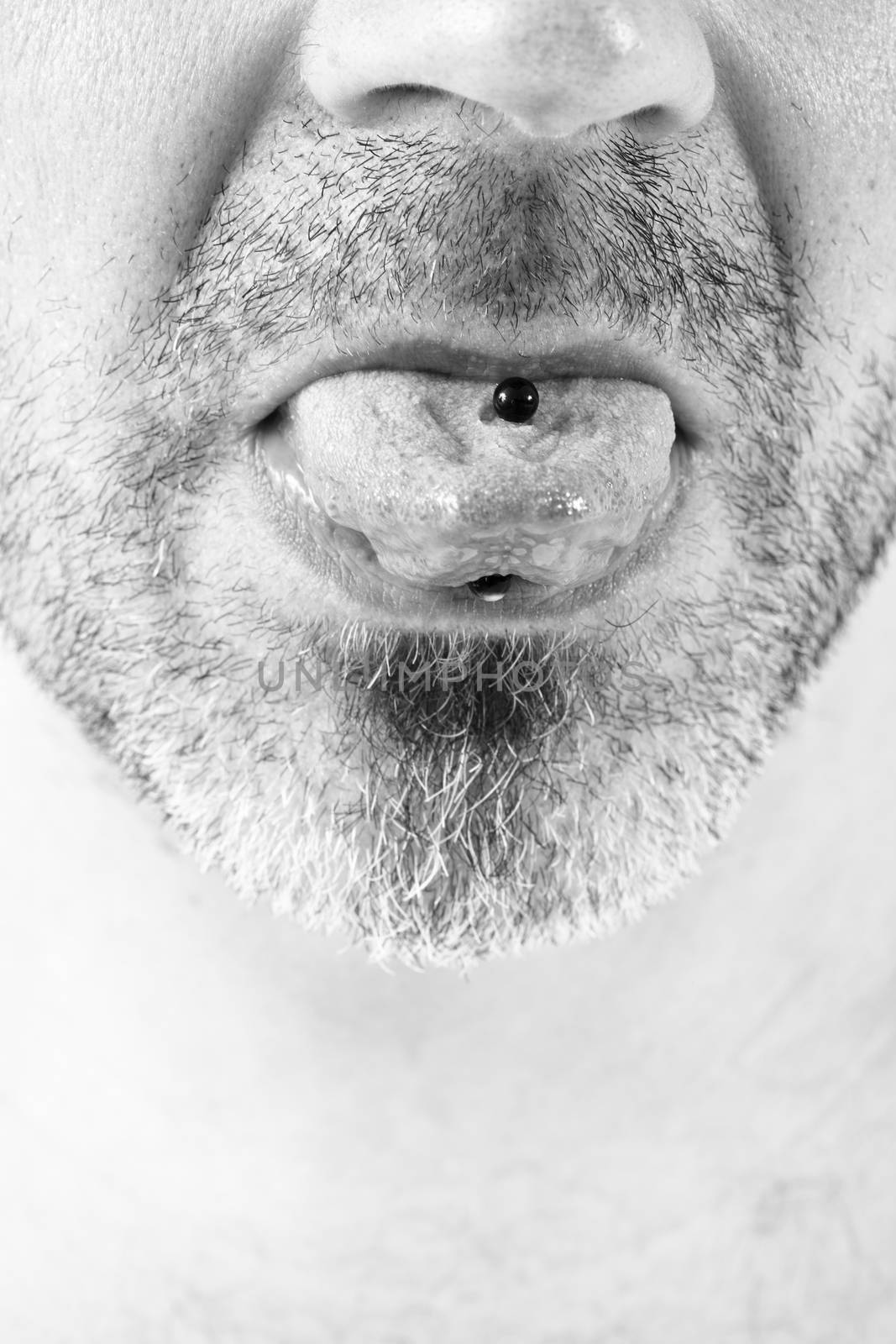 close-up of a mature man showing off his tongue ring